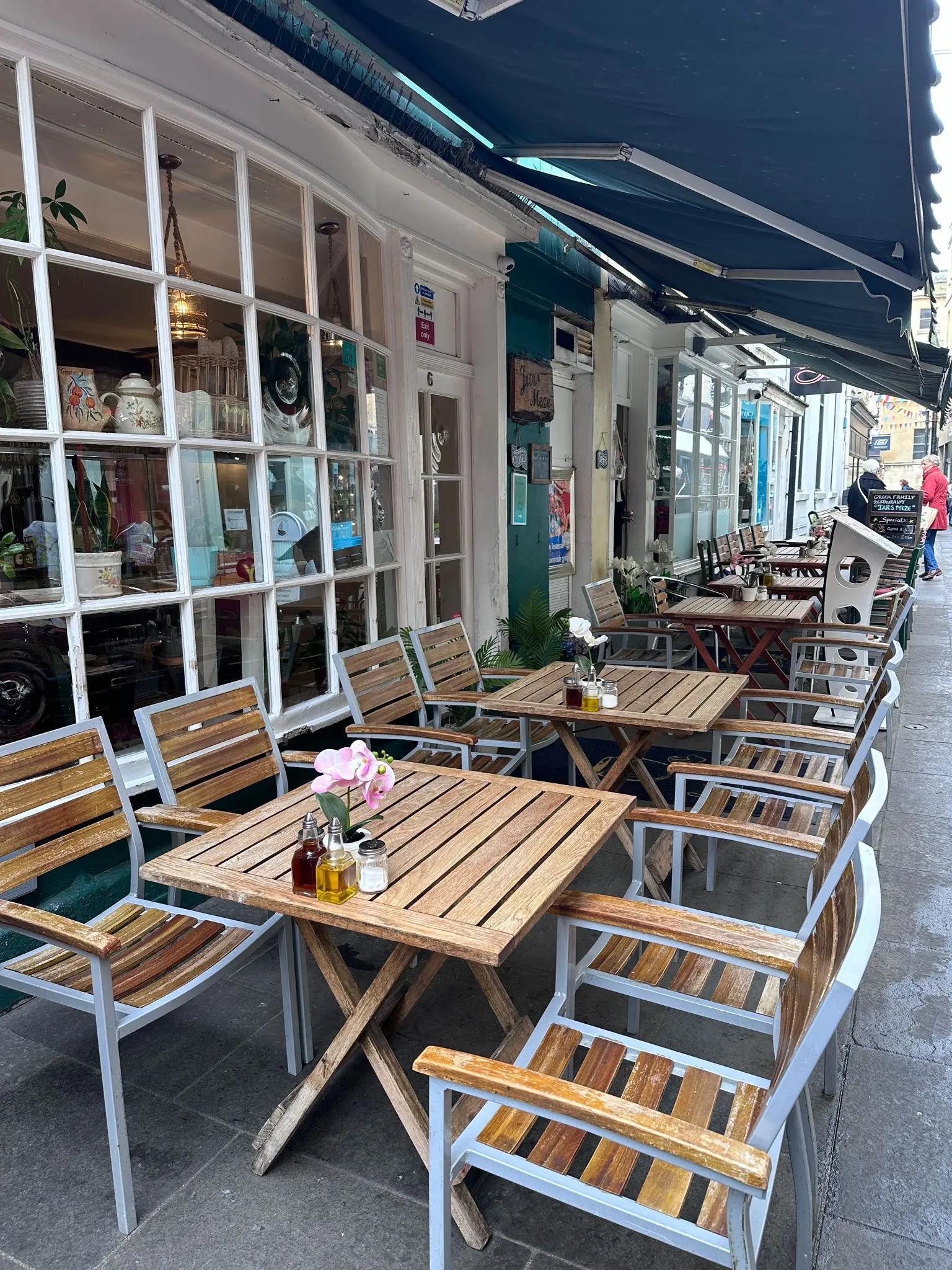 The front entry of Jars Meze in Bath, showing the restaurant door and outdoor seating arrangements.